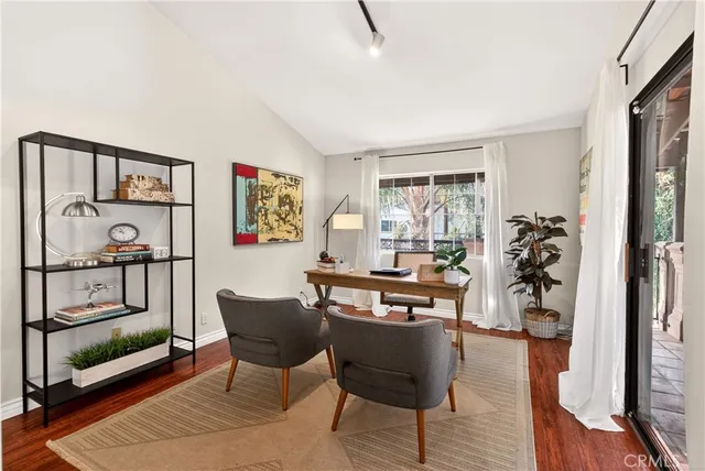 a view of a livingroom with furniture and a window