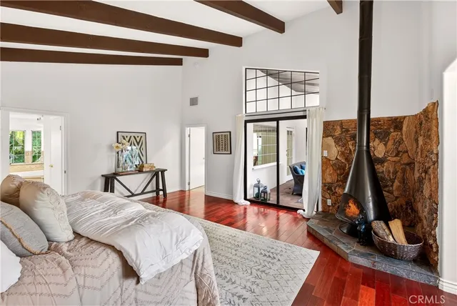 a bedroom with a bed and a mirror