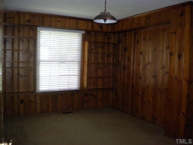2221 Lash Avenue Raleigh, NC 27607 - Photo 15 of 17 Lower Level Bedroom- all wood paneling and built-in shelving. Bedroom