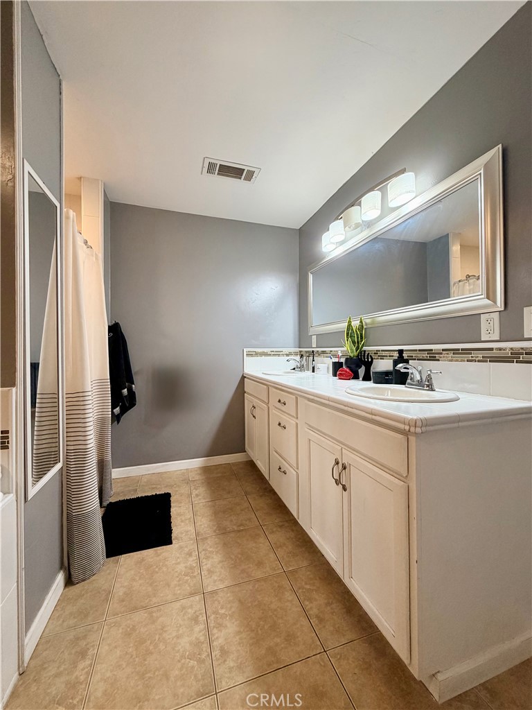 1896 Maryvale Lane Hemet, CA 92544 - Photo 22 of 33 a spacious bathroom with a double vanity sink and a mirror