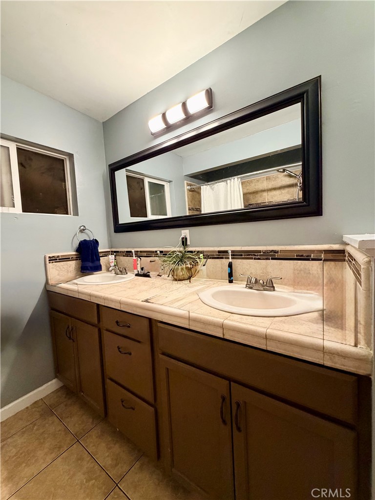 1896 Maryvale Lane Hemet, CA 92544 - Photo 26 of 33 a bathroom with a double vanity sink and a mirror