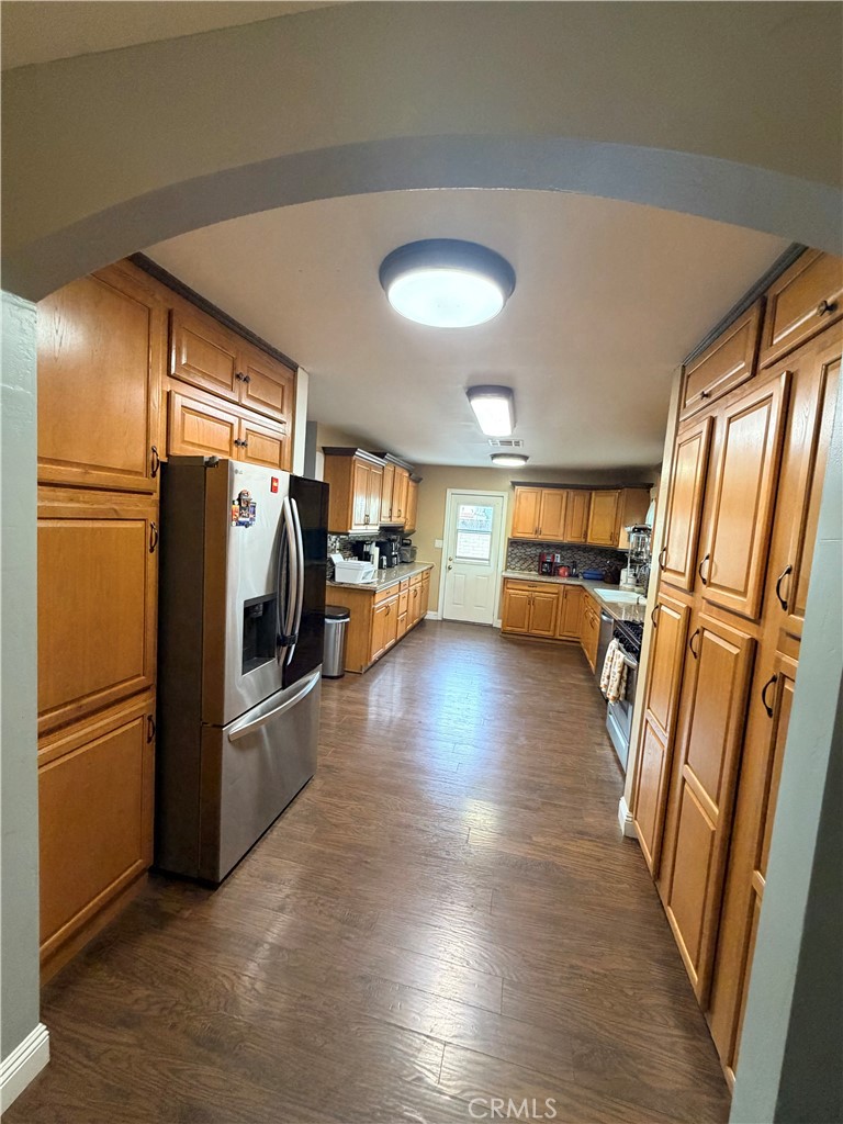1896 Maryvale Lane Hemet, CA 92544 - Photo 8 of 33 a view of a refrigerator in kitchen and wooden floor
