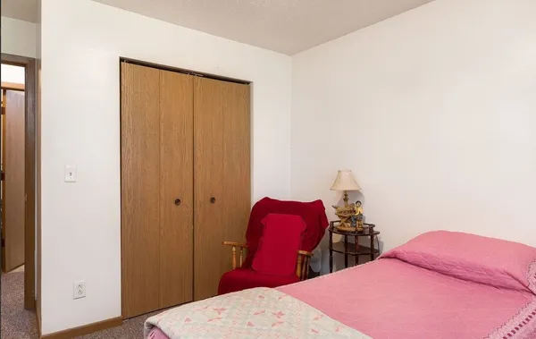 a bedroom with two bed and a closet