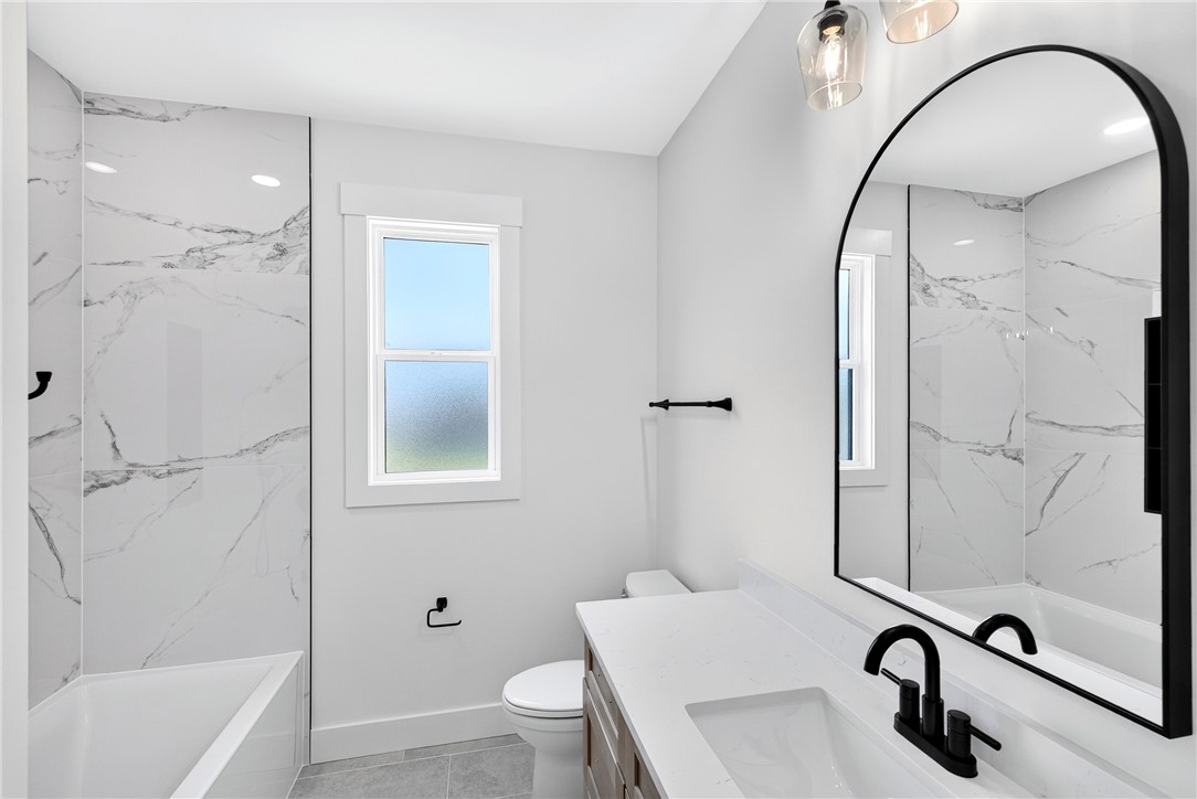 416 Blume Road Anderson, SC 29625 - Photo 16 of 29 A well-appointed bath features stylish fixtures, marble-patterned tile, and a practical window.