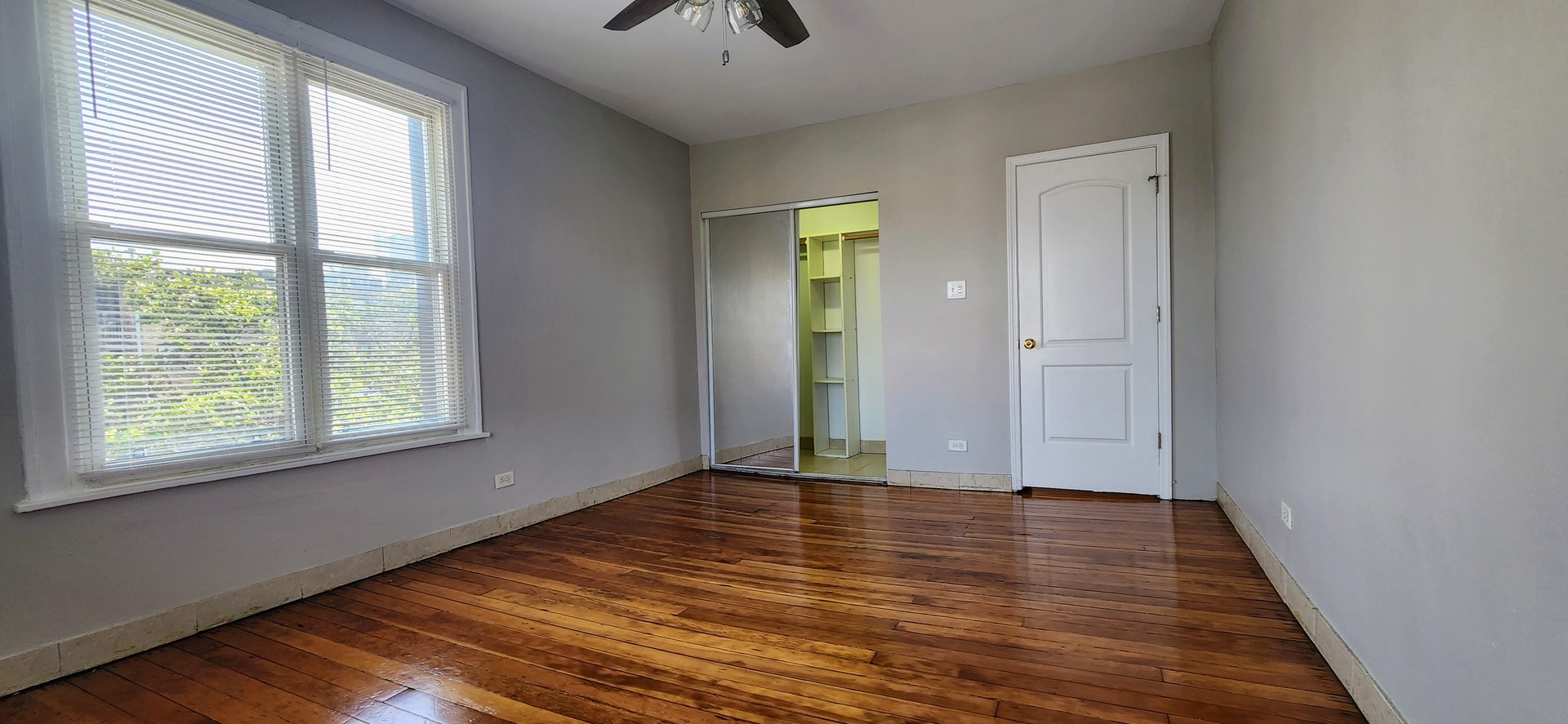 4764 North Virginia Avenue, Unit 206 Chicago, IL 60625 - Photo 9 of 16 a view of an empty room with wooden floor and a window
