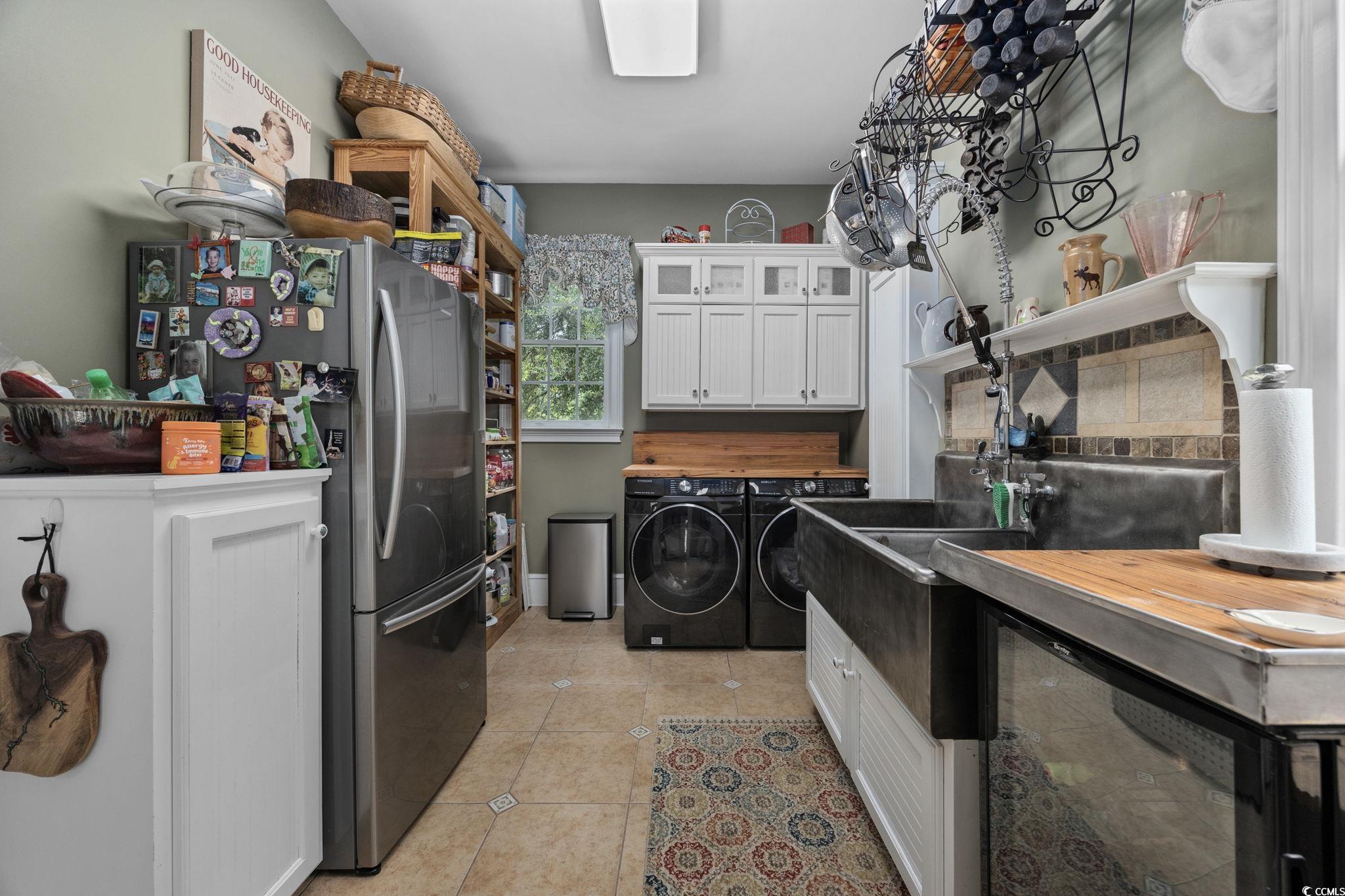 3750 Highway 813 Conway Sc 29526 Conway, SC 29526 - Photo 15 of 40 Laundry area featuring light tile patterned floors, washing machine and dryer, and cabinet space