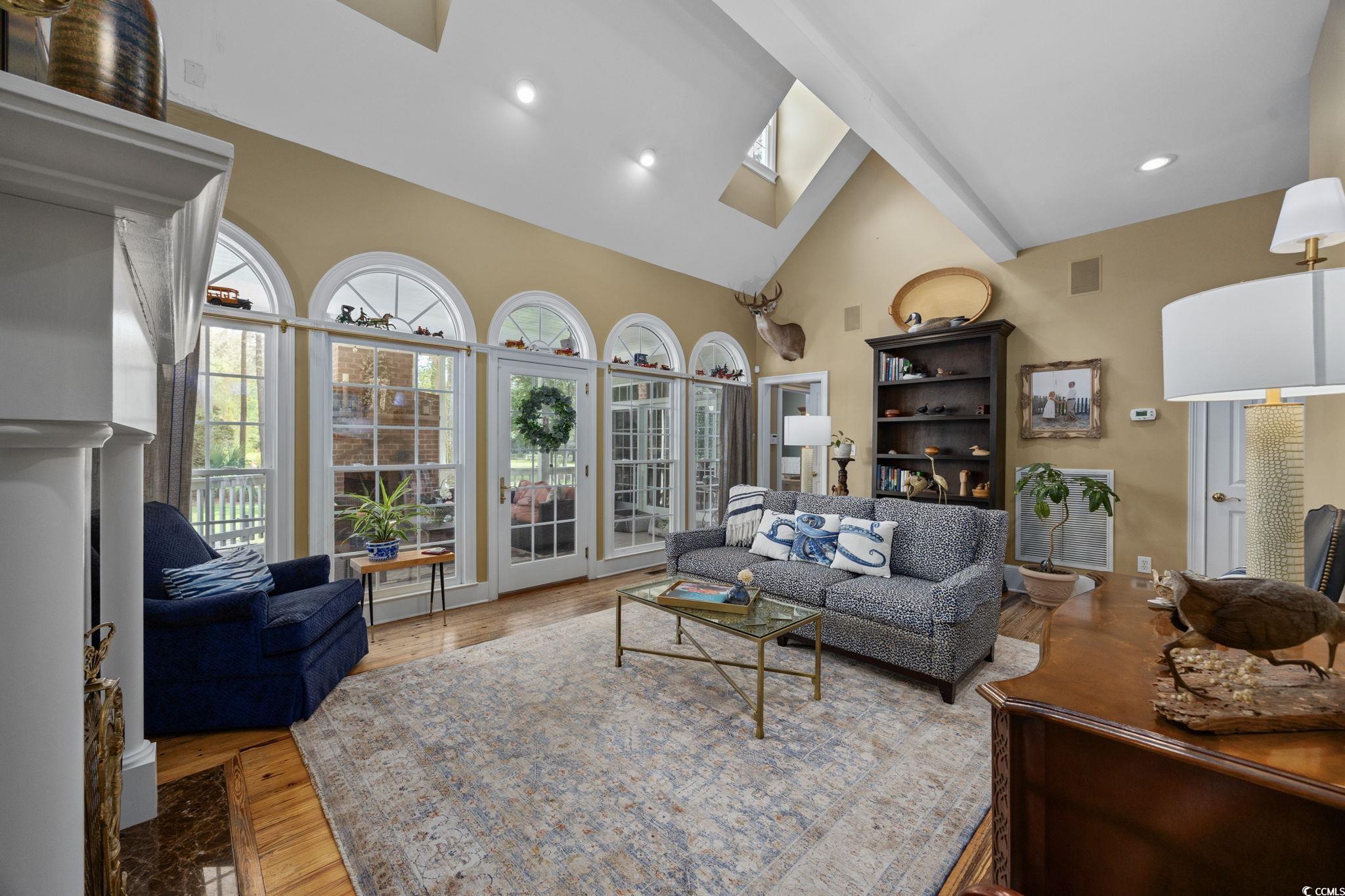 3750 Highway 813 Conway Sc 29526 Conway, SC 29526 - Photo 9 of 40 Living room featuring a skylight, light wood finished floors, high vaulted ceiling, recessed lighting, and a fireplace
