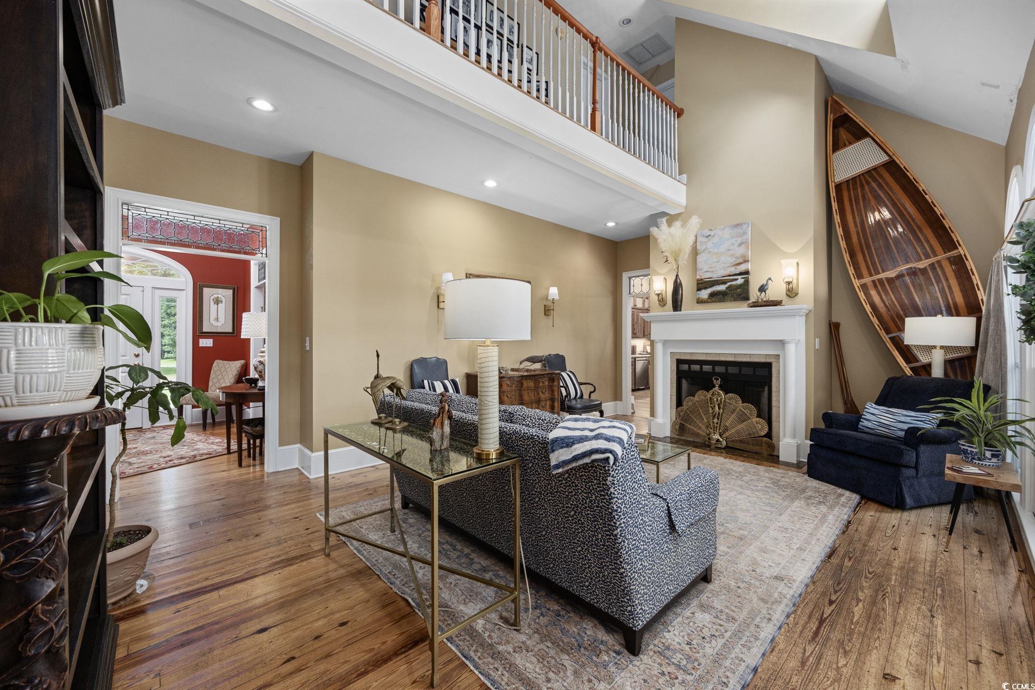 3750 Highway 813 Conway Sc 29526 Conway, SC 29526 - Photo 10 of 40 Living area featuring a tiled fireplace, hardwood / wood-style floors, a towering ceiling, and recessed lighting