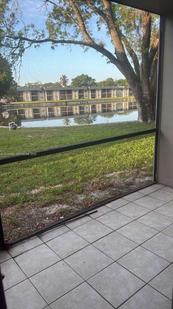 7910 North Colony Circle, Unit 101 Tamarac, FL 33321 - Photo 1 of 17 a front view of a house with a yard