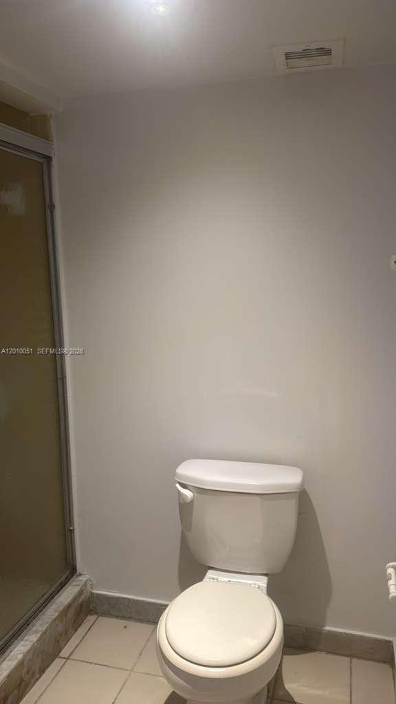 7910 North Colony Circle, Unit 101 Tamarac, FL 33321 - Photo 12 of 17 a white toilet sitting next to a shower