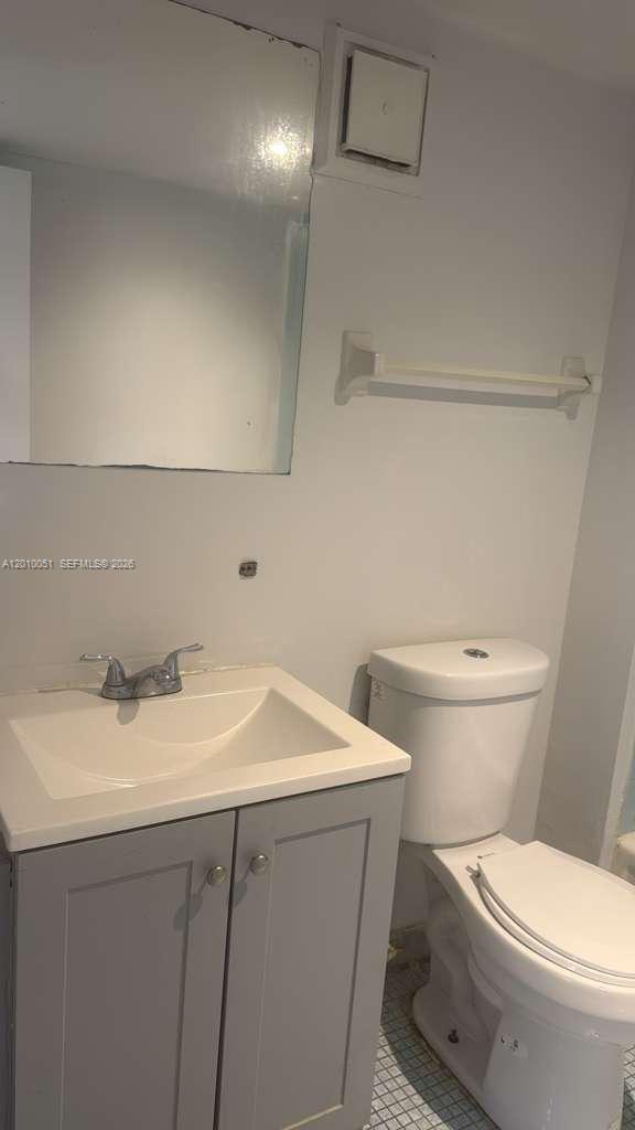 7910 North Colony Circle, Unit 101 Tamarac, FL 33321 - Photo 16 of 17 a bathroom with a sink a toilet and vanity