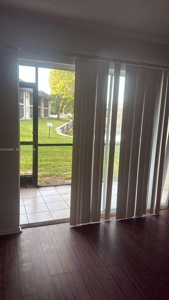 7910 North Colony Circle, Unit 101 Tamarac, FL 33321 - Photo 2 of 17 a view of entryway with wooden floor