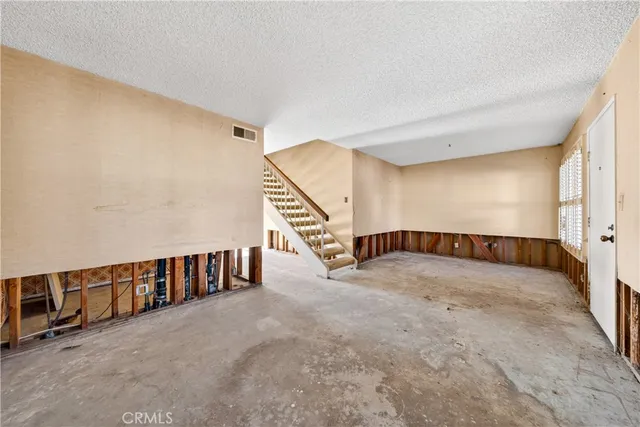 a view of an empty room with stairs