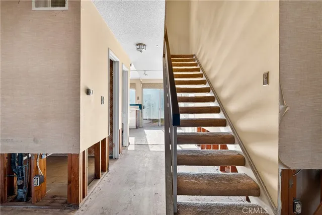 a view of a hallway with wooden floor and entryway