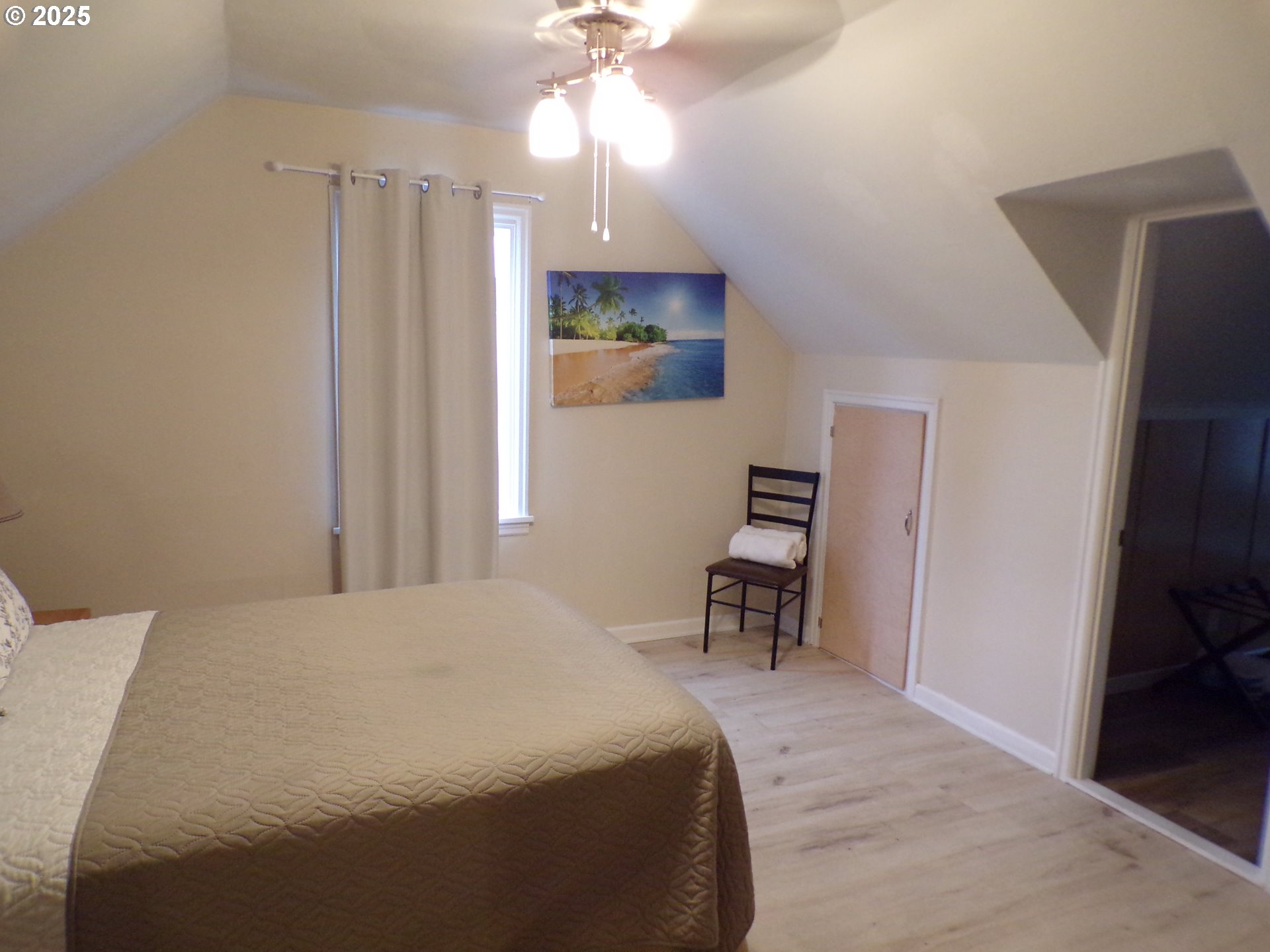 960 Shipping Street Northeast Salem, OR 97301 - Photo 19 of 29 a bedroom with a bed and a chandelier