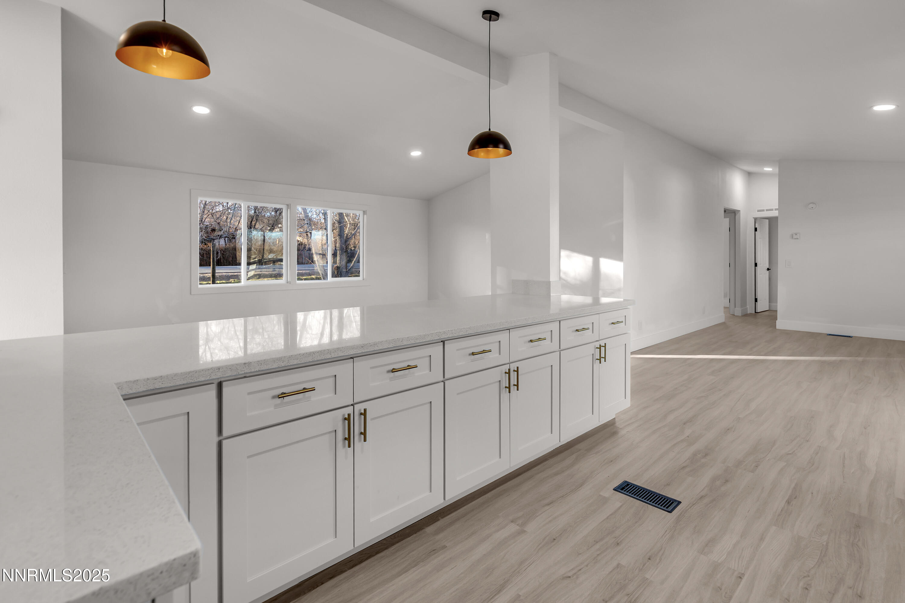 320 Ramsey Way Reno, NV 89506 - Photo 11 of 40 a kitchen with white cabinets and wooden floor