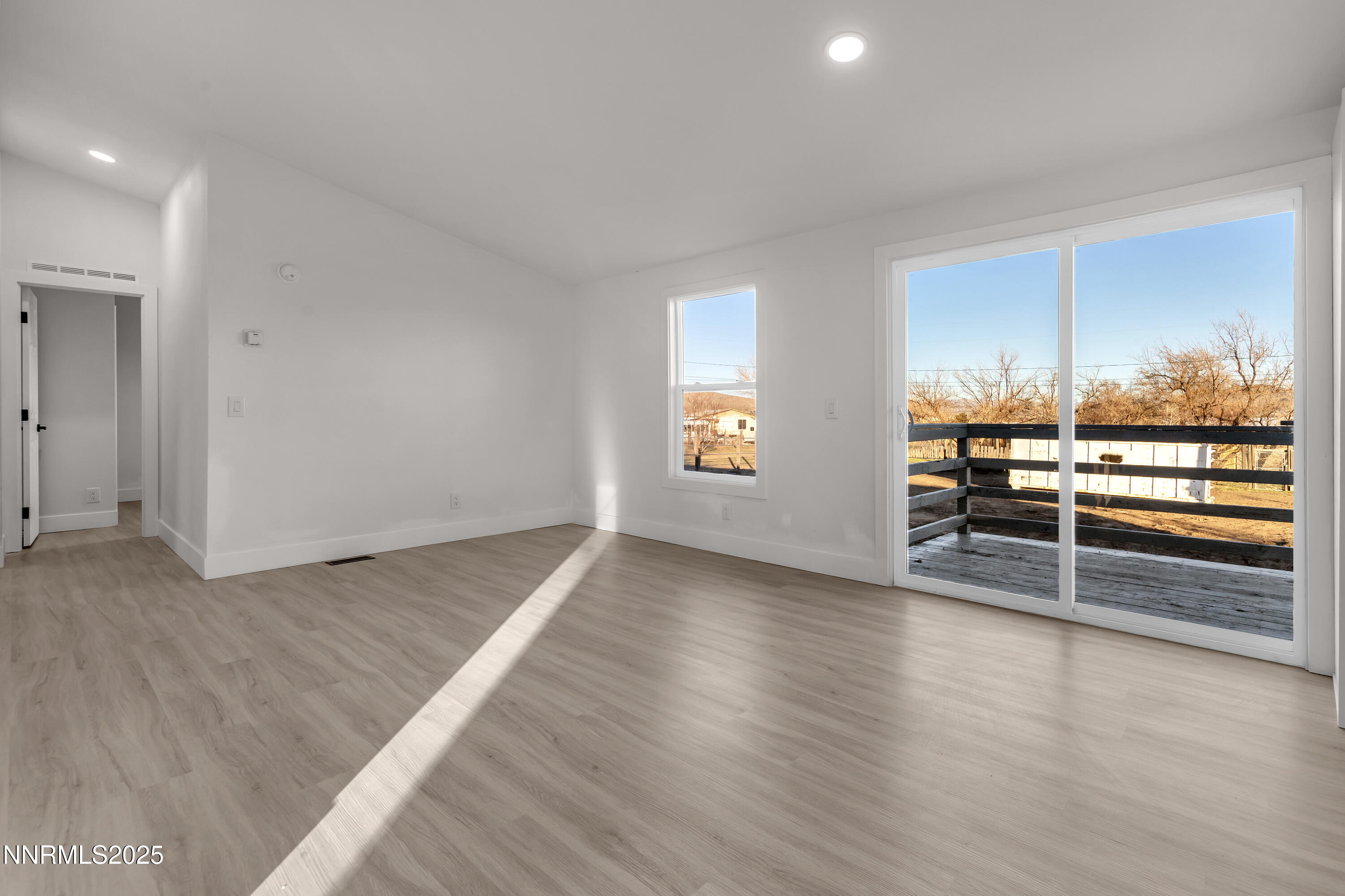320 Ramsey Way Reno, NV 89506 - Photo 14 of 40 an empty room with wooden floor and windows