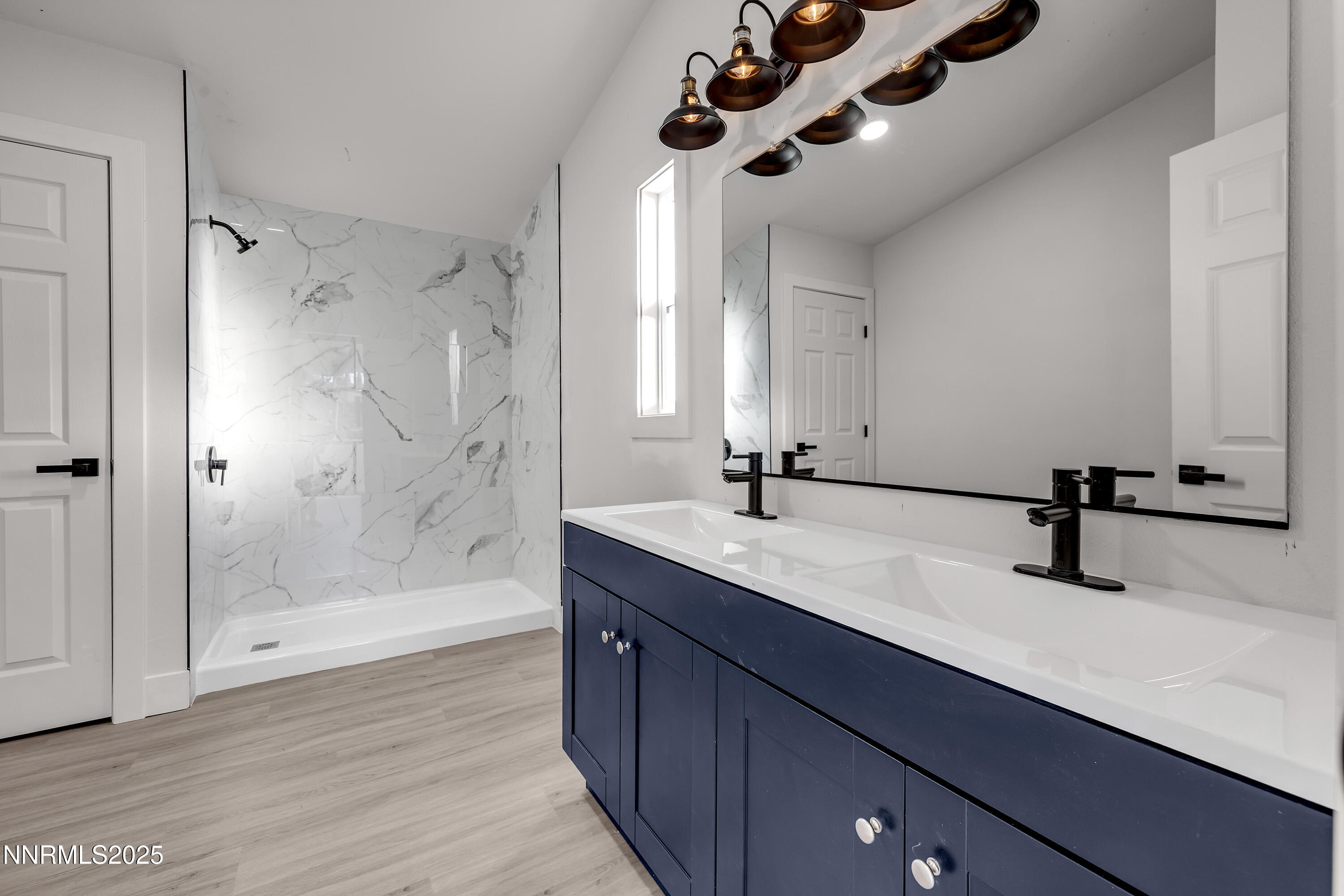 320 Ramsey Way Reno, NV 89506 - Photo 19 of 40 a bathroom with a double vanity sink a mirror and a shower