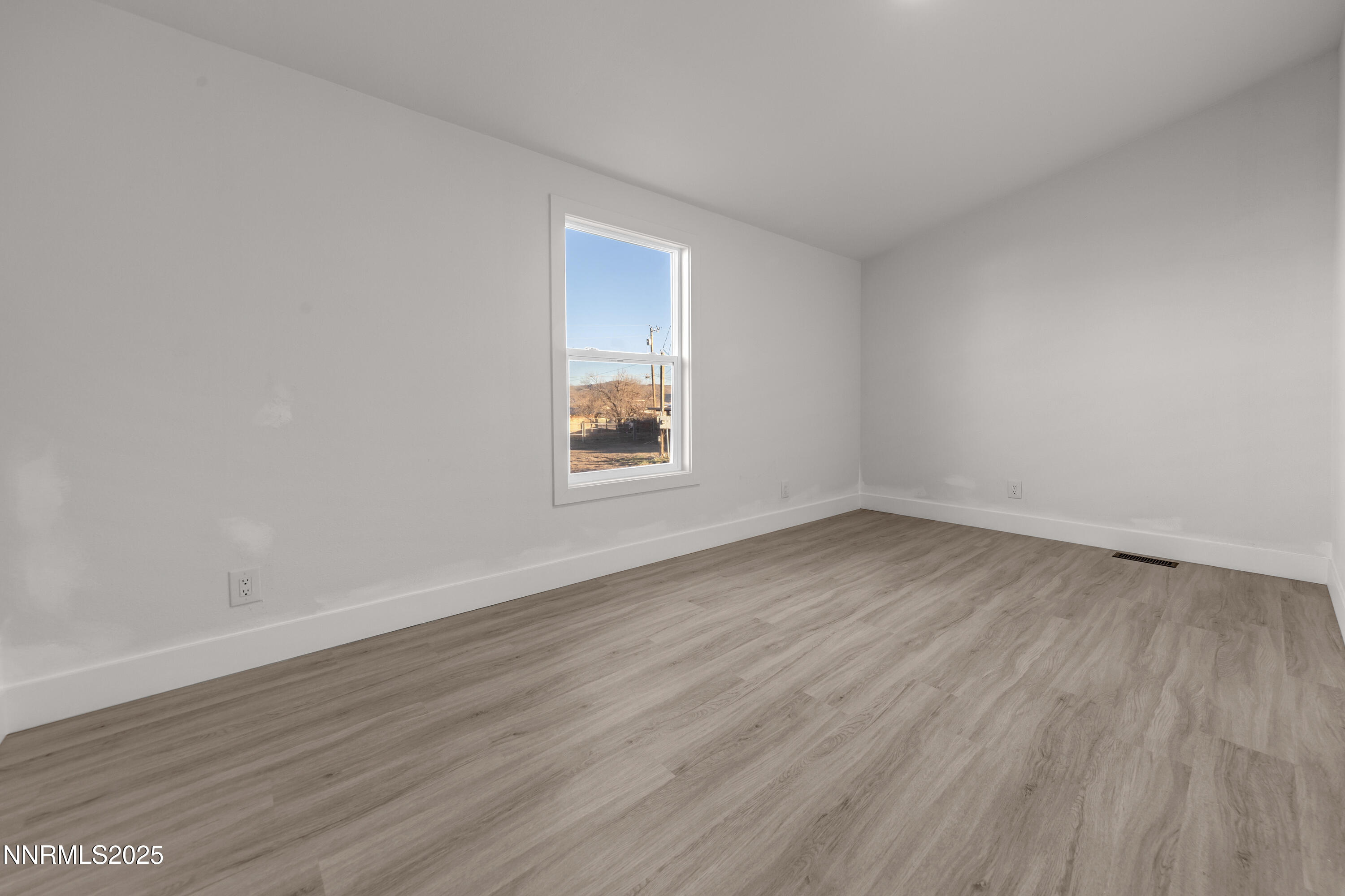 320 Ramsey Way Reno, NV 89506 - Photo 23 of 40 an empty room with wooden floor and windows