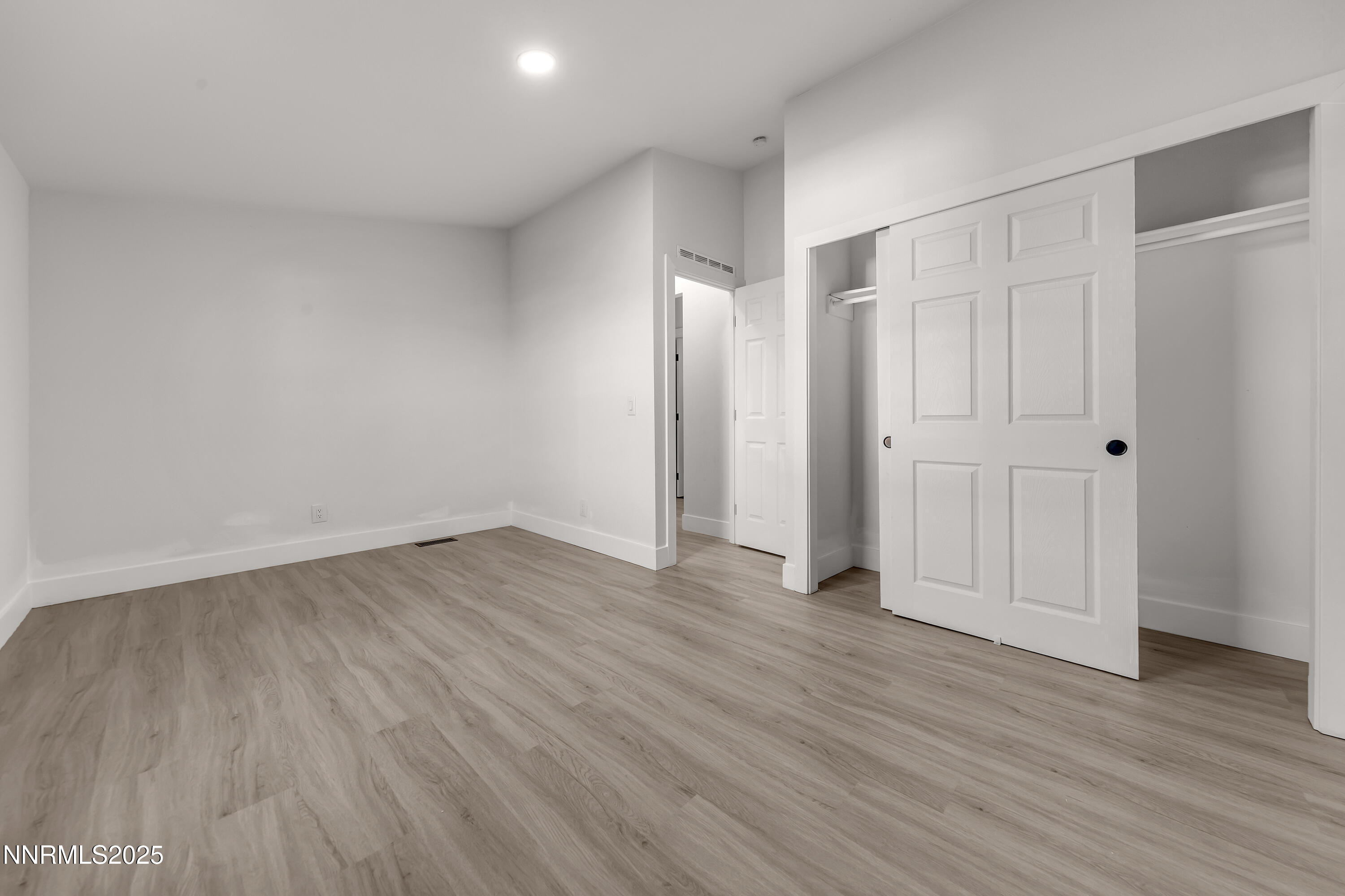 320 Ramsey Way Reno, NV 89506 - Photo 24 of 40 a view of an empty room with wooden floor