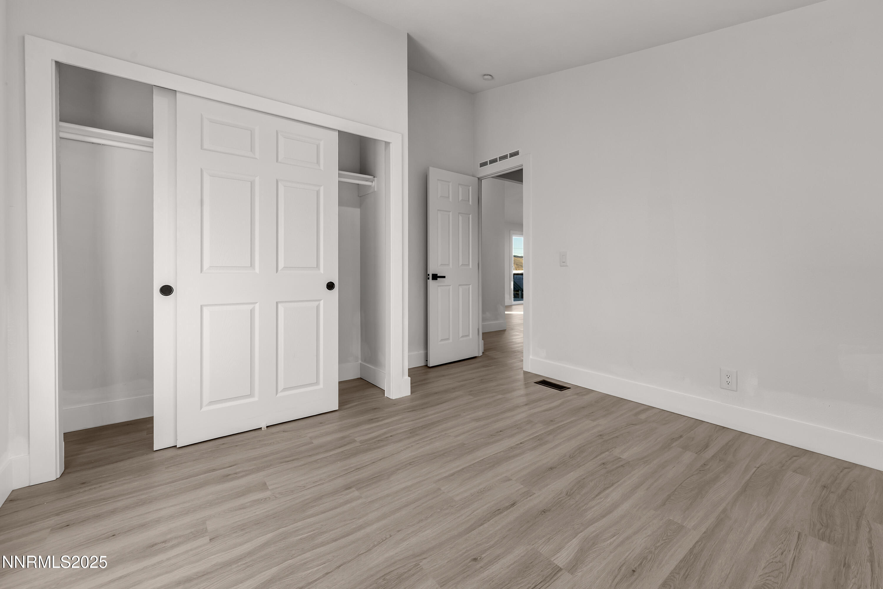 320 Ramsey Way Reno, NV 89506 - Photo 26 of 40 a view of an empty room with wooden floor