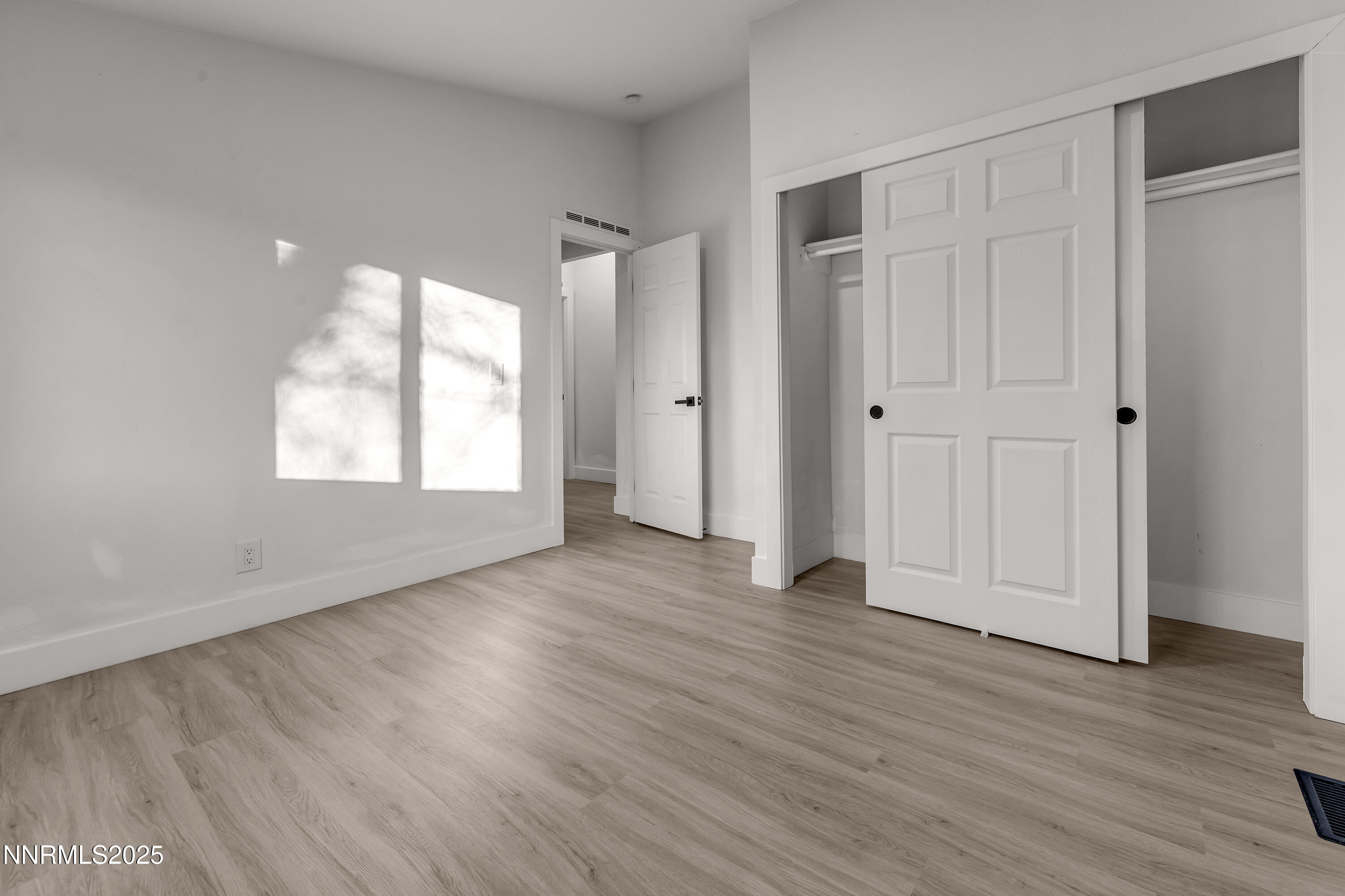 320 Ramsey Way Reno, NV 89506 - Photo 28 of 40 a view of an empty room with wooden floor and a window