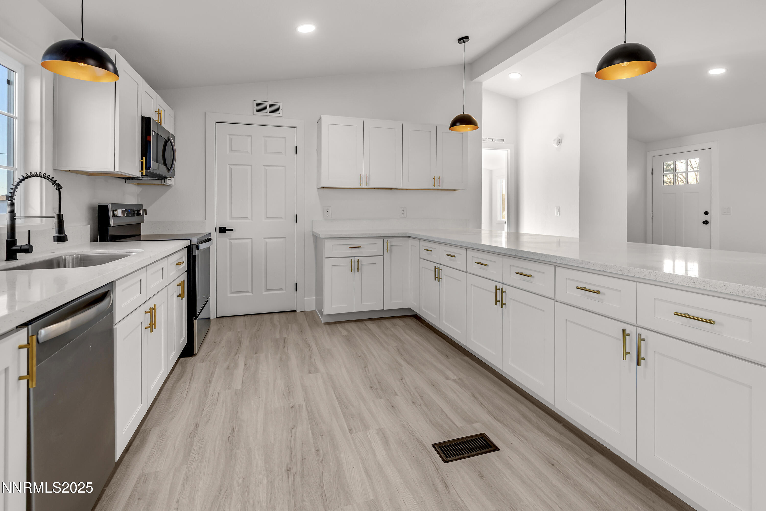 320 Ramsey Way Reno, NV 89506 - Photo 3 of 40 a kitchen with cabinets a sink and wooden floor