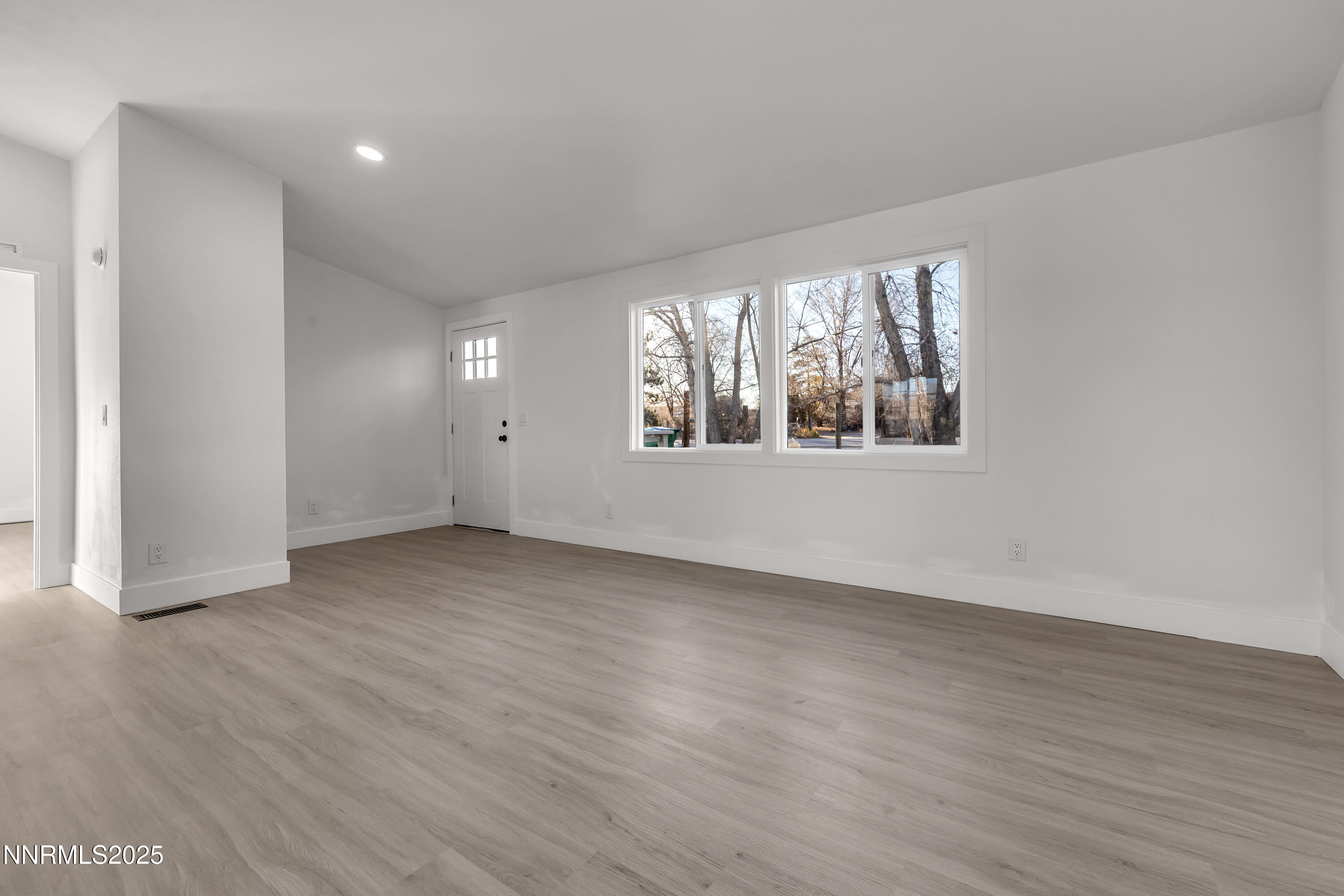 320 Ramsey Way Reno, NV 89506 - Photo 7 of 40 an empty room with wooden floor and windows
