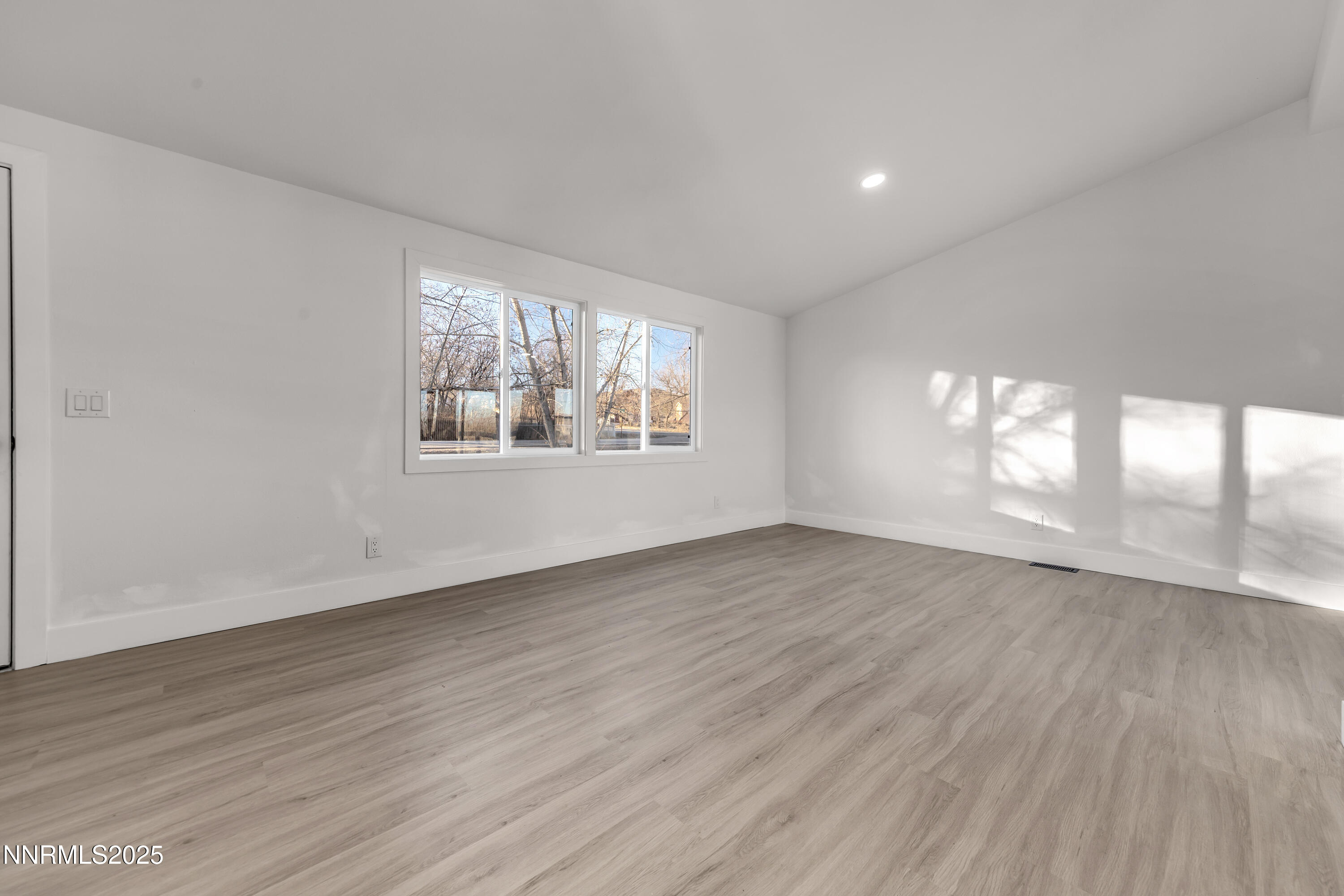 320 Ramsey Way Reno, NV 89506 - Photo 8 of 40 an empty room with wooden floor and windows