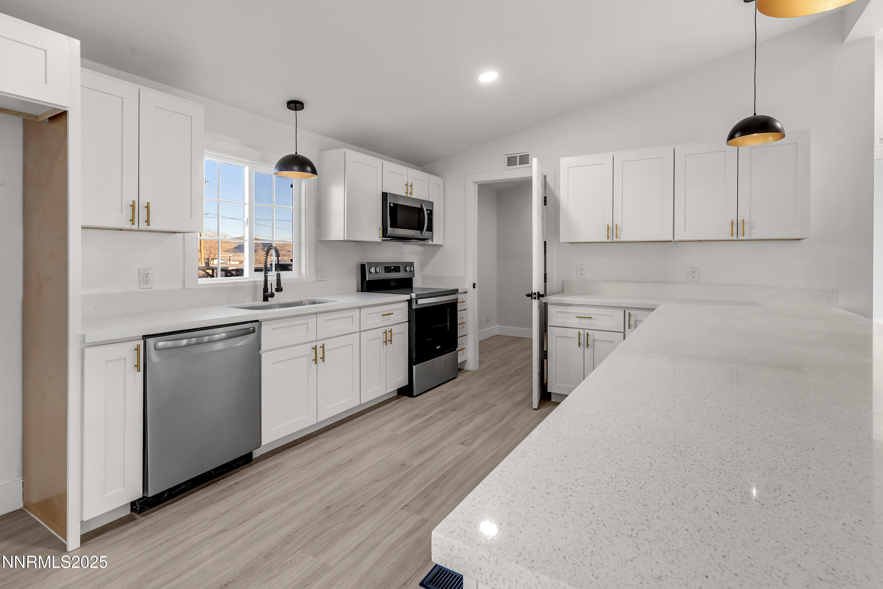 320 Ramsey Way Reno, NV 89506 - Photo 9 of 40 a kitchen with white cabinets and white appliances