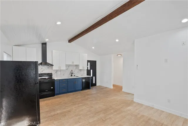 a large kitchen with a refrigerator and a sink