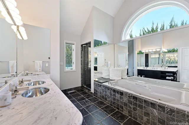 a bedroom with a bed a window and walk in closet