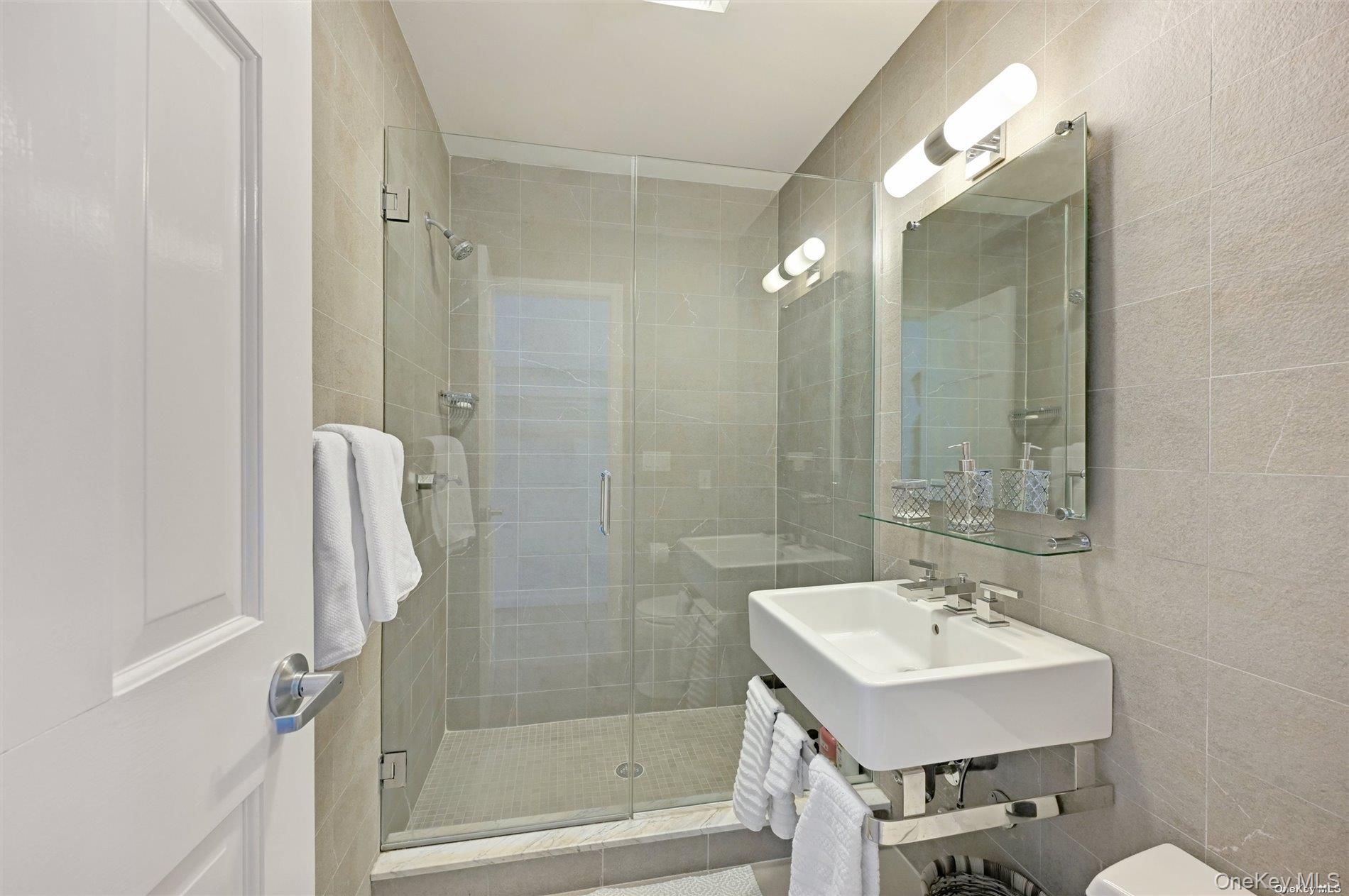 16 Laila Lane Remsenburg, NY 11960 - Photo 14 of 36 a bathroom with a sink a toilet and shower