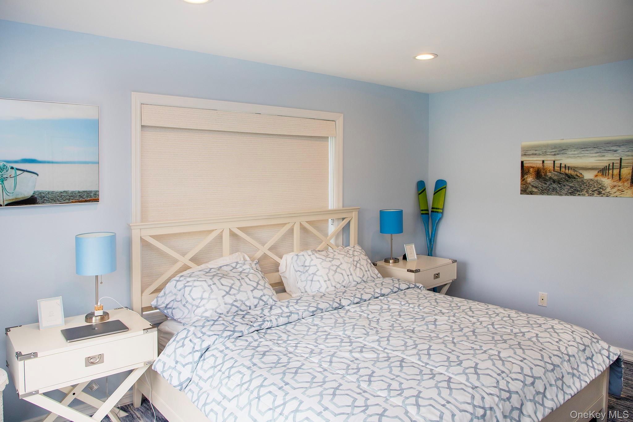 16 Laila Lane Remsenburg, NY 11960 - Photo 19 of 36 a large bed sitting in a bedroom next to a window