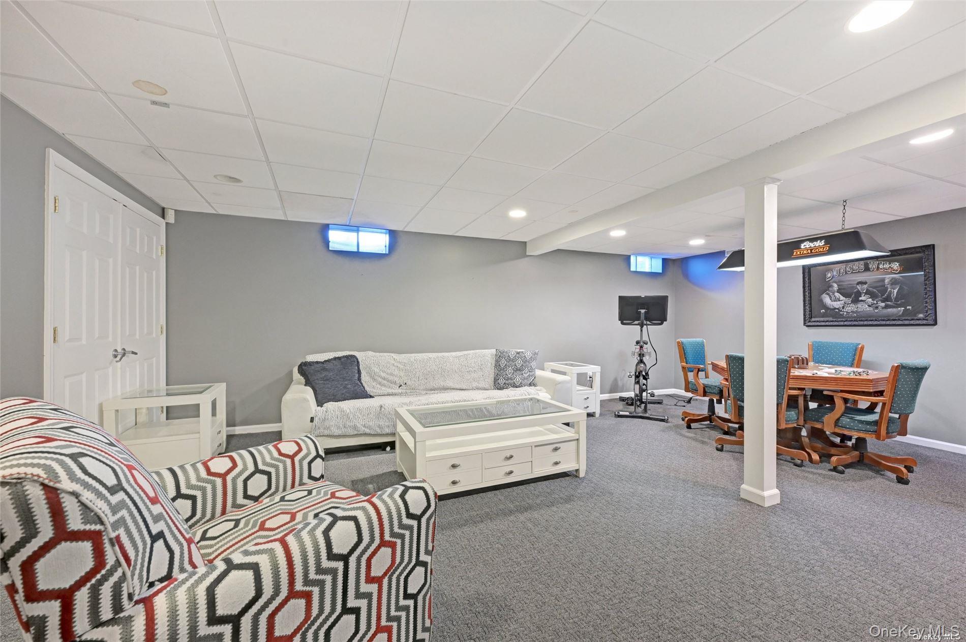 16 Laila Lane Remsenburg, NY 11960 - Photo 20 of 36 a living room with furniture and a chair