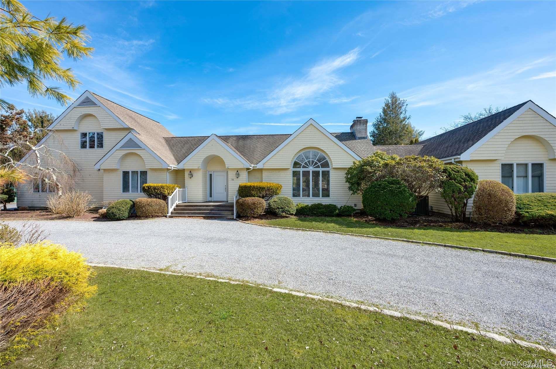 16 Laila Lane Remsenburg, NY 11960 - Photo 2 of 36 a front view of a house with a yard and garage