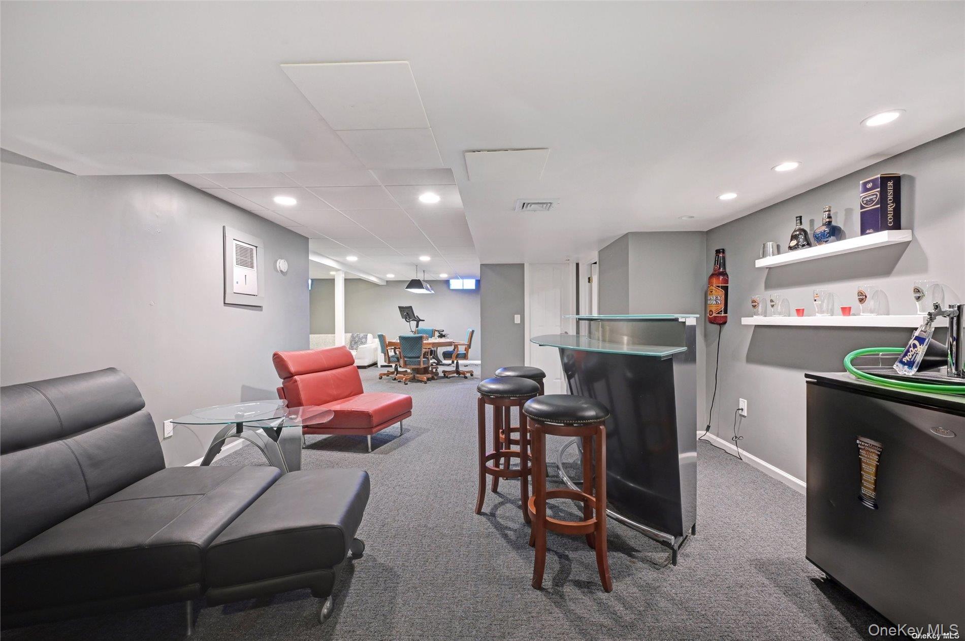 16 Laila Lane Remsenburg, NY 11960 - Photo 22 of 36 a living room with furniture a flat screen tv and kitchen view