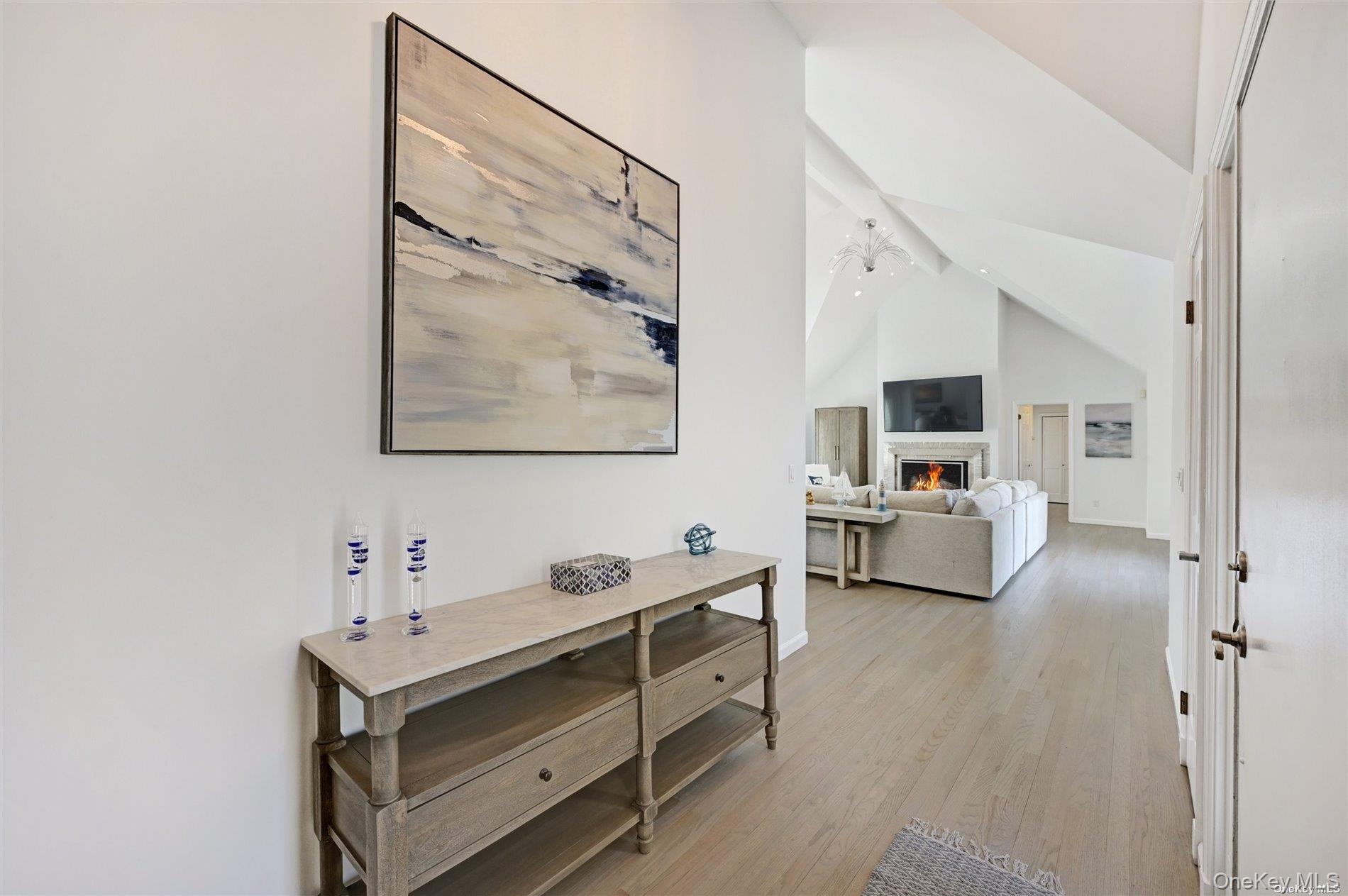 16 Laila Lane Remsenburg, NY 11960 - Photo 3 of 36 a room with furniture a flat tv screen and white walls