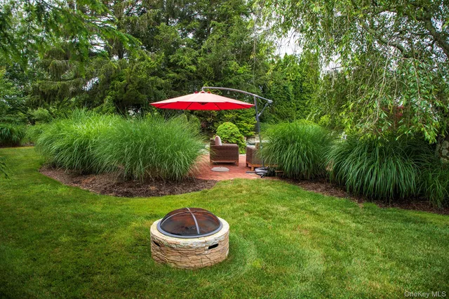 a view of a backyard with a tub and fire pit