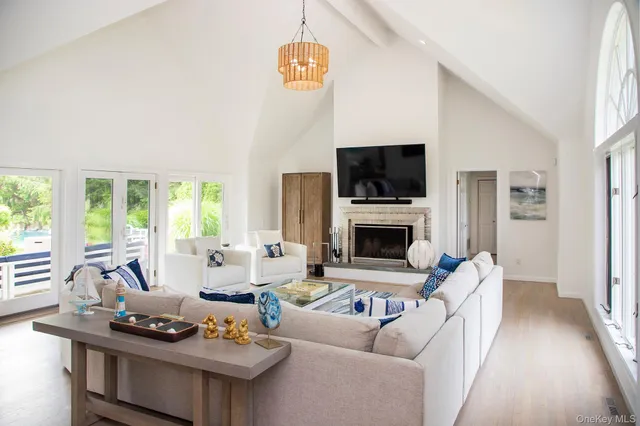 a living room with furniture a fireplace and a flat screen tv
