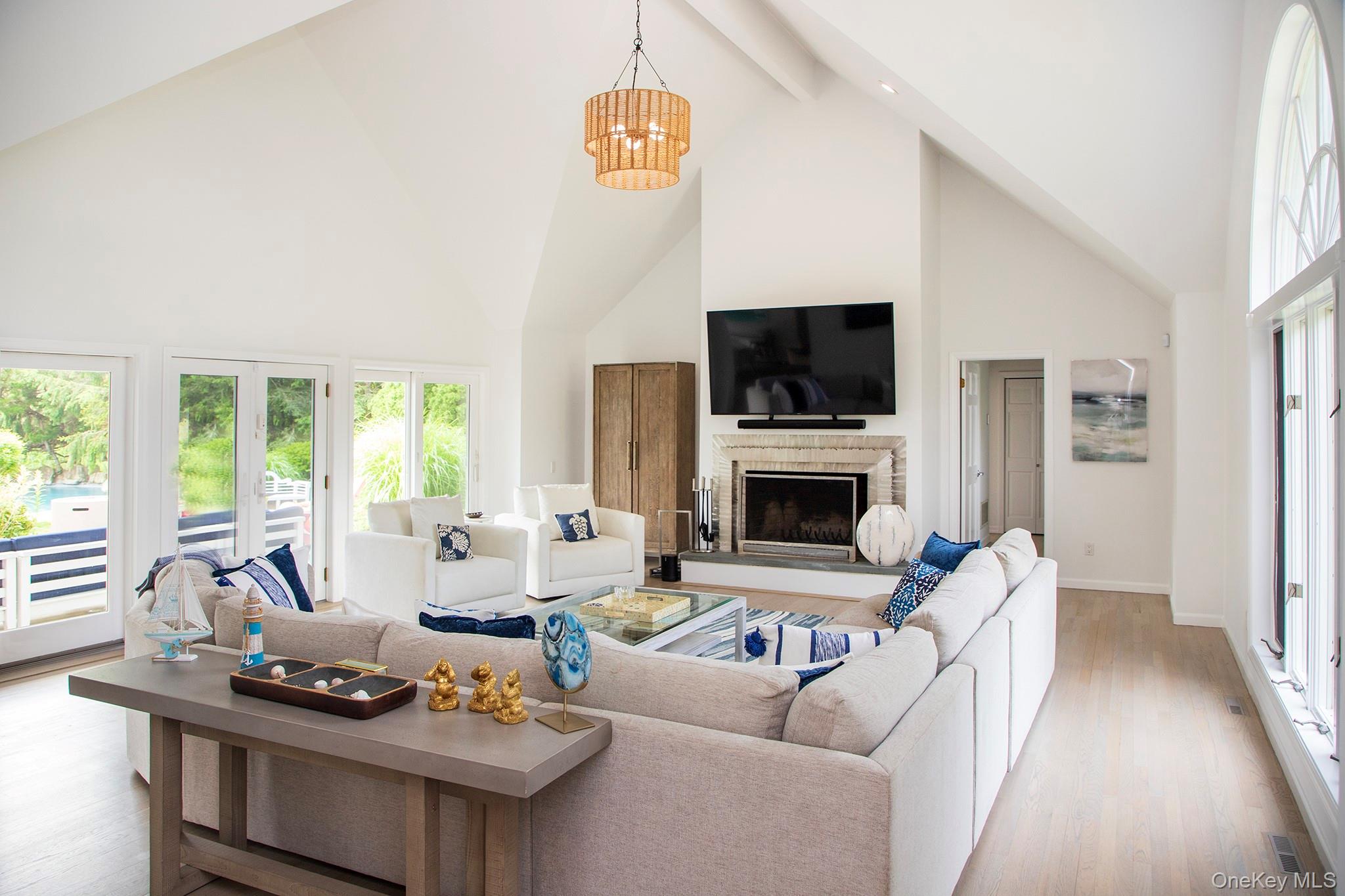 16 Laila Lane Remsenburg, NY 11960 - Photo 5 of 36 a living room with furniture a fireplace and a flat screen tv