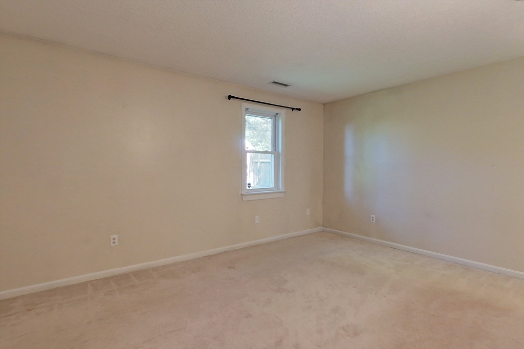 103 Main Street, Unit 10 Pepperell, MA 01463 - Photo 10 of 22 an empty room with windows and closet