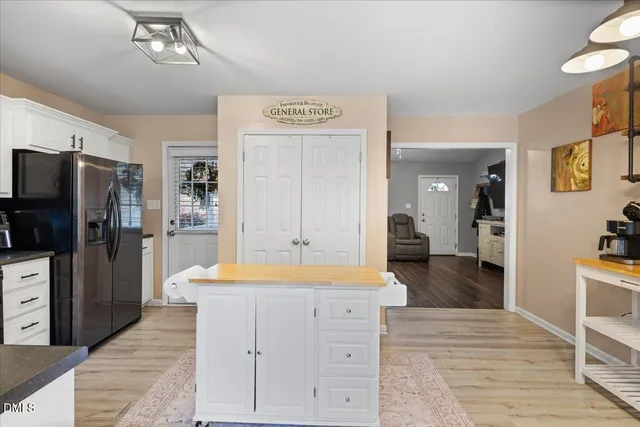 a spacious bathroom with a granite countertop sink a mirror and shower