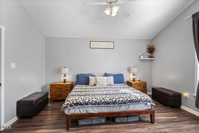 a bedroom with a bed and wooden floor