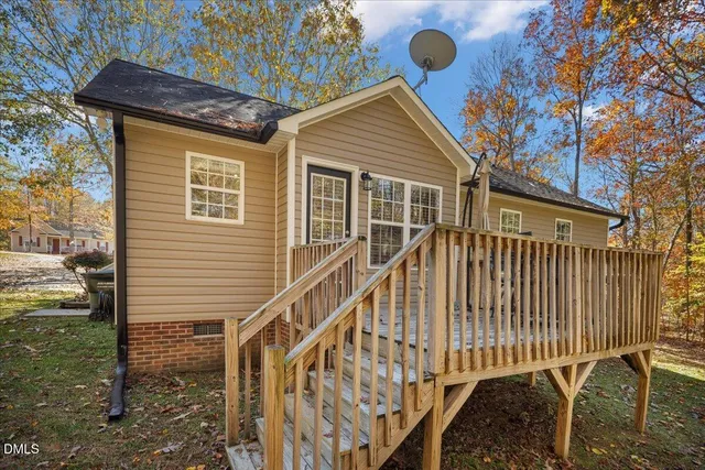 a view of a house with backyard and deck