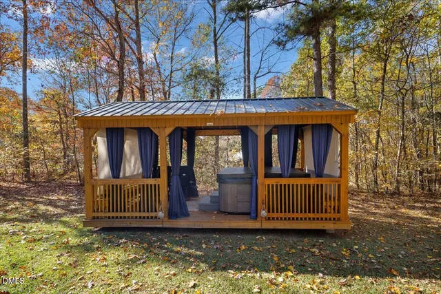 a view of a house with a yard porch and wooden floor