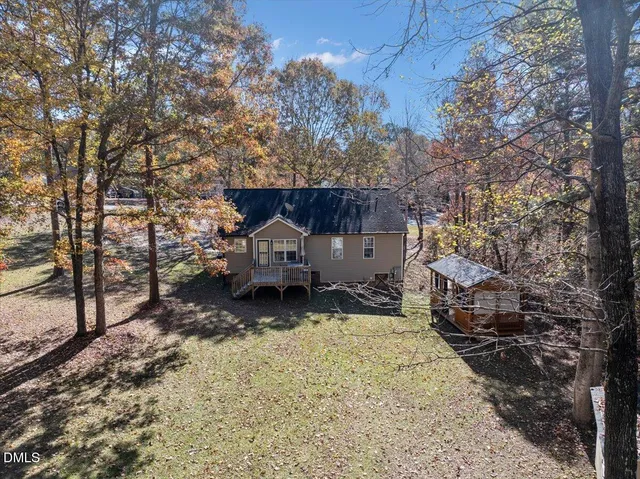 a backyard of a house with barbeque oven table and chairs