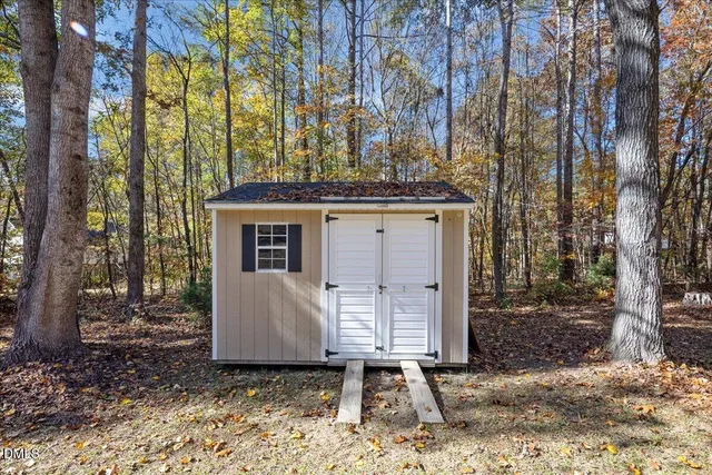 a view of a house with a yard and tree s