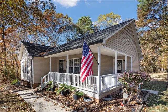 a front view of house with a garden