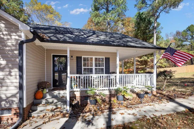 a view of a patio with a table chairs and a small yard